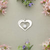 A love heart charm with zirconia hanging in the centre