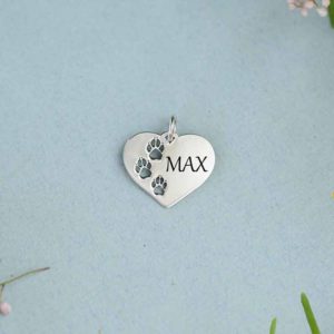 A pretty silver heart with paw prints. Customise with your pets name.