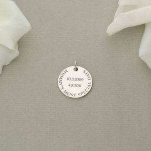 A Silver Circle with Special Dates and Quotes