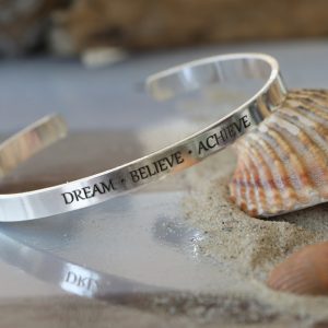 A 5mm wide silver bangle with engraving. Prices start from £29