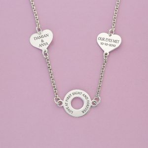 Silver necklace with circle charm and hearts