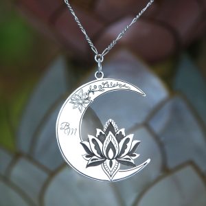 A silver charm with the lotus flower and half moon.