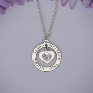 A circular charm with a centre heart which can be engraved finger print front and simple engraving on the back